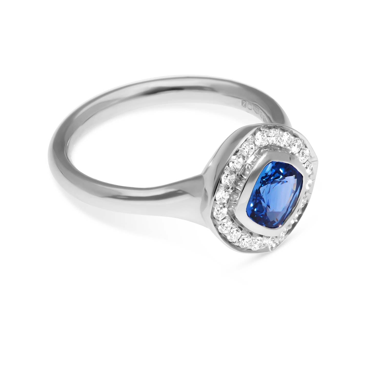 FRAME Platinum Cushion Blue Sapphire Ring with Diamond Halo by ethical jewellers E.C.One London, made in our B Corp London workshop