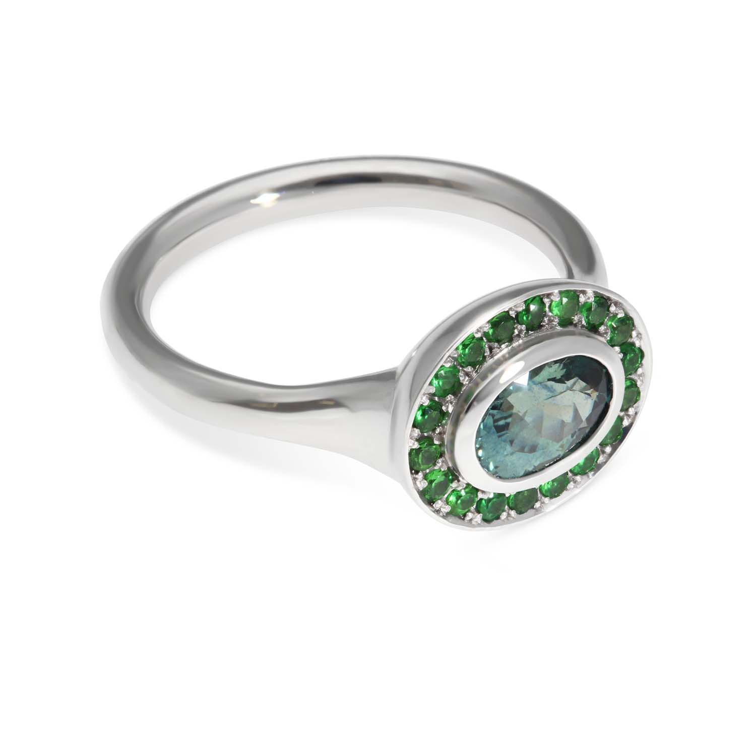 FRAME Platinum Oval Teal Sapphire Ring with Tsavorite Halo by ethical jewellers E.C.One London, made in our B Corp London workshop